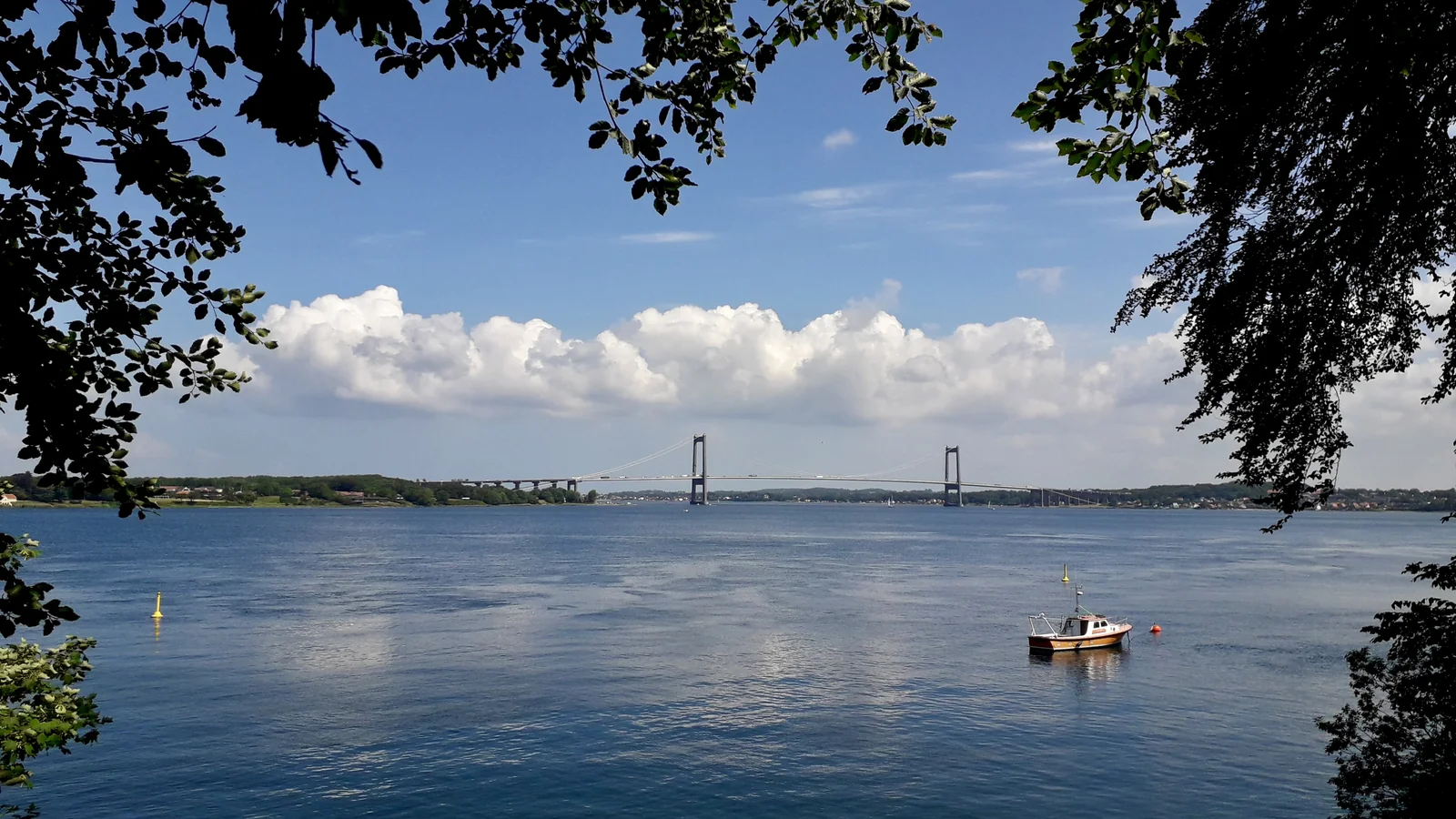 Suspension bridge over blue water under a blue sky, illustrating how to bridge ETH from Ethereum to Arbitrum