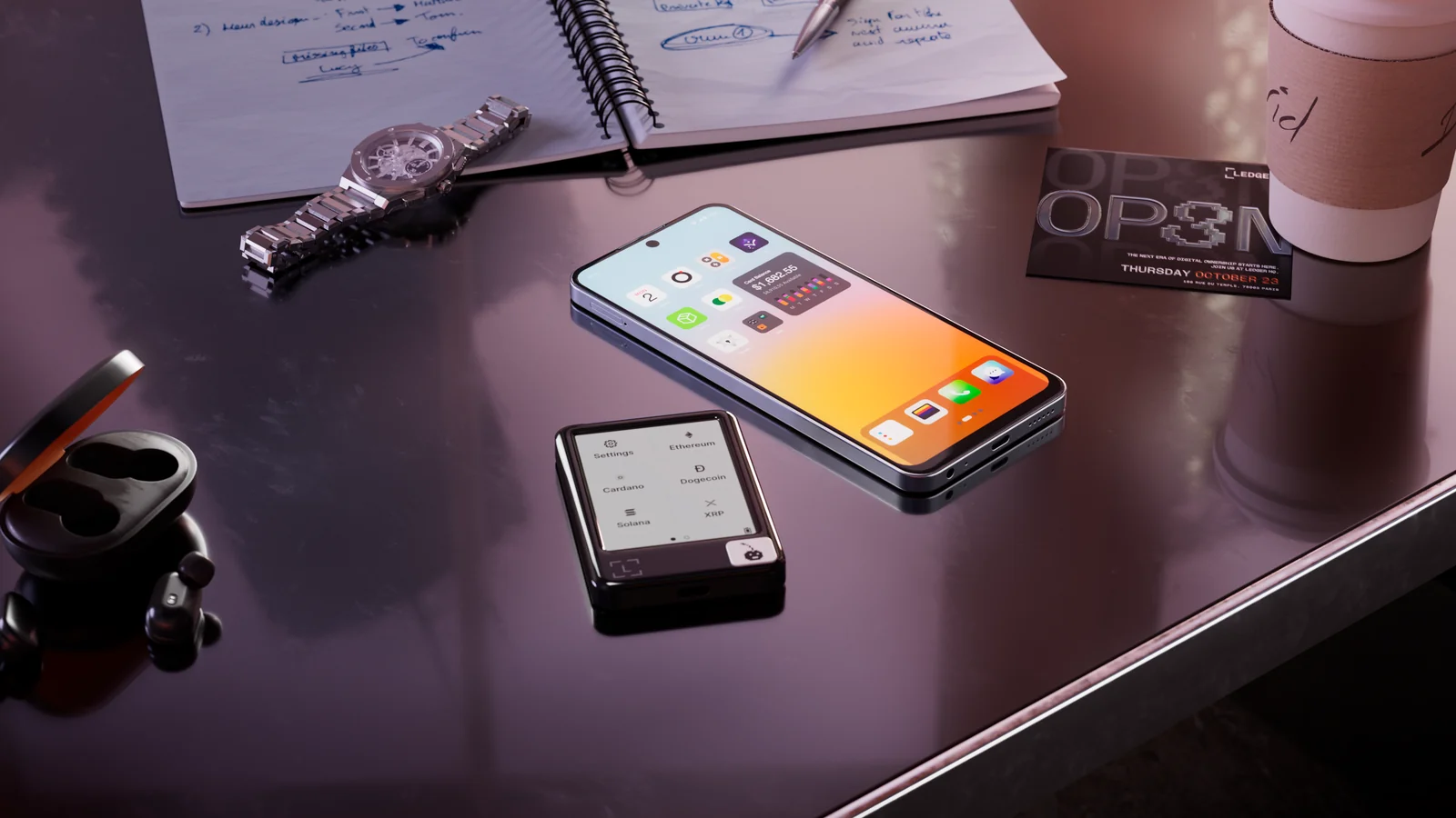 A smartphone and a Ledger hardware wallet side by side on a desk, the two devices involved when you move crypto from a hot wallet to a hardware wallet
