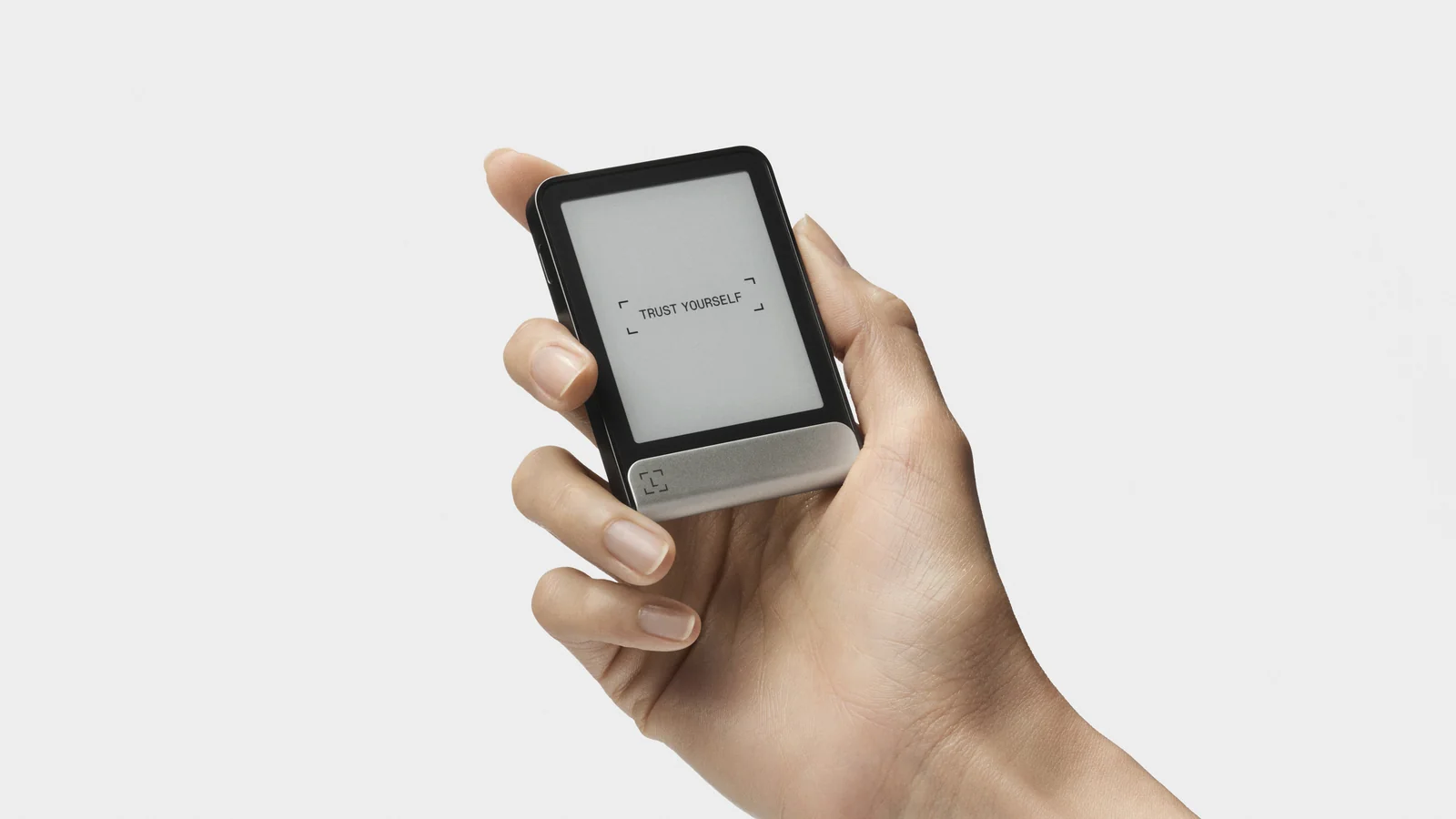 A hand holding a Ledger Flex hardware wallet, the touchscreen model used to enter a 24-word seed phrase