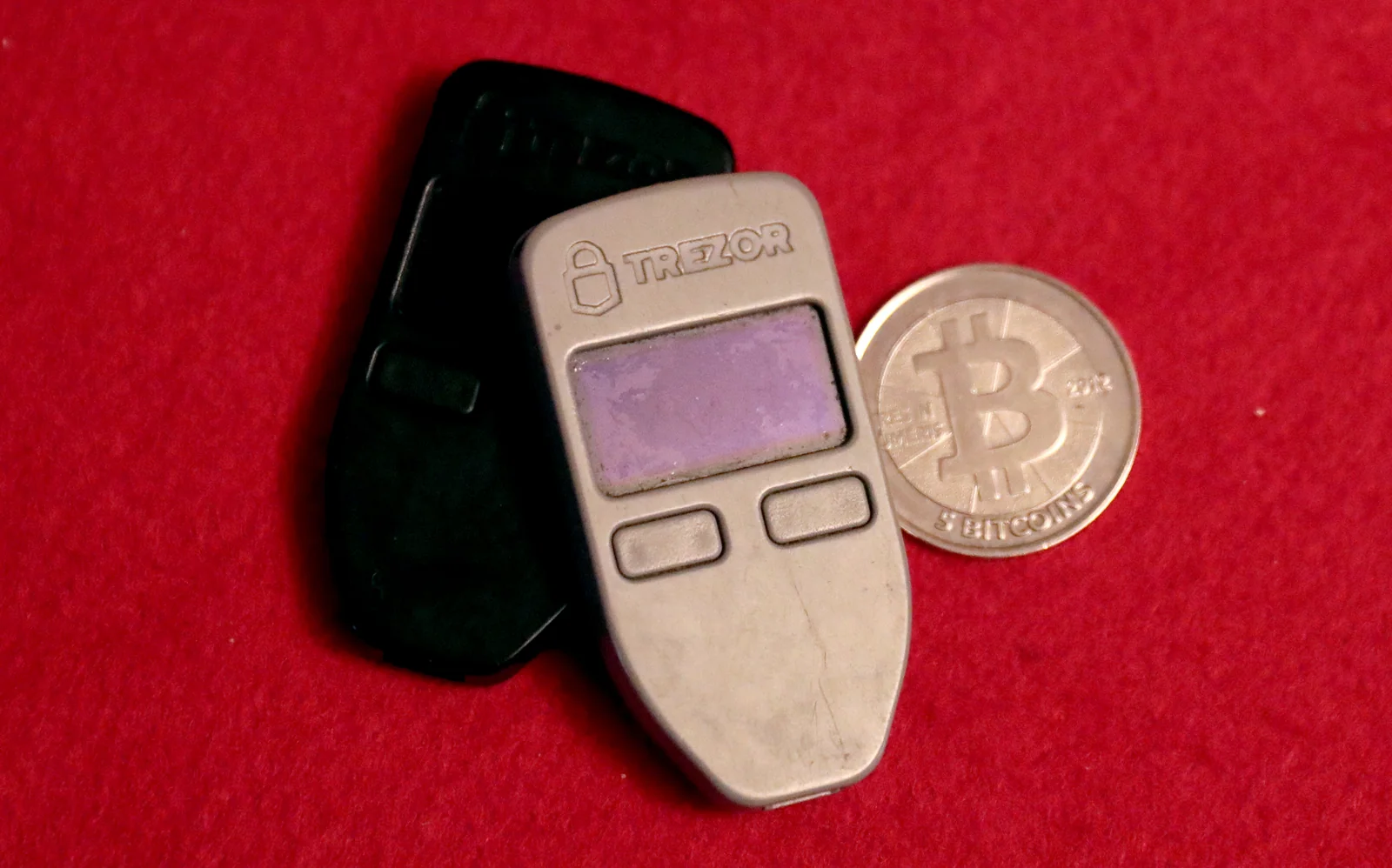 Two Trezor One hardware wallets on a desk, the devices used to recover a Trezor wallet from a seed phrase