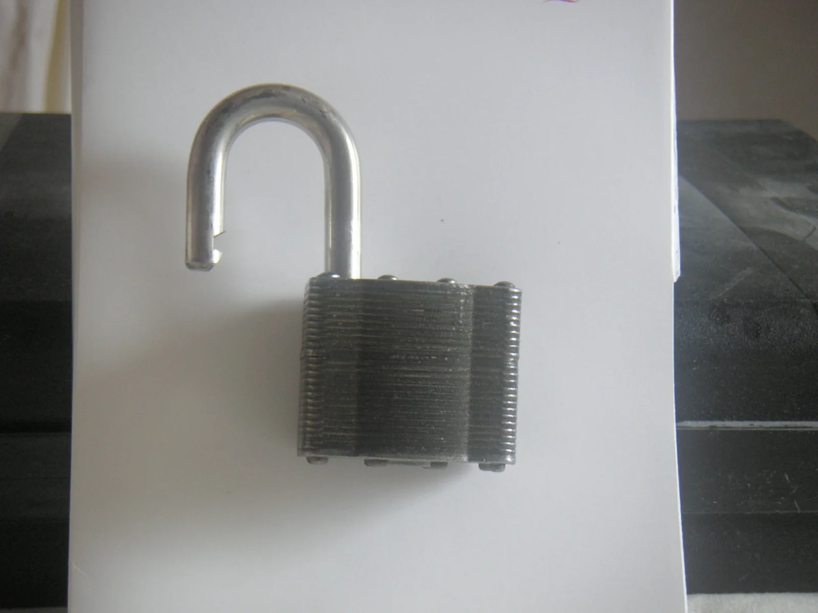 An open steel padlock on a white background, standing for a token approval left open until you revoke it