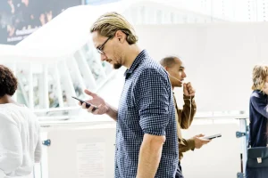 A man using his smartphone while walking, illustrating how to send USDT from a phone