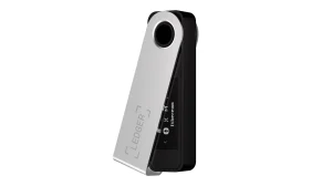 A Ledger Nano S Plus hardware wallet with its steel cover swivelled open, showing the small OLED screen