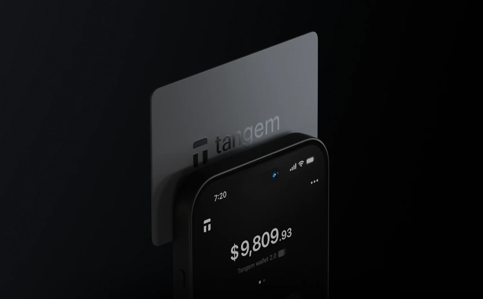 A Tangem Wallet card held against the top of a phone running the Tangem app, the position used to scan the card over NFC