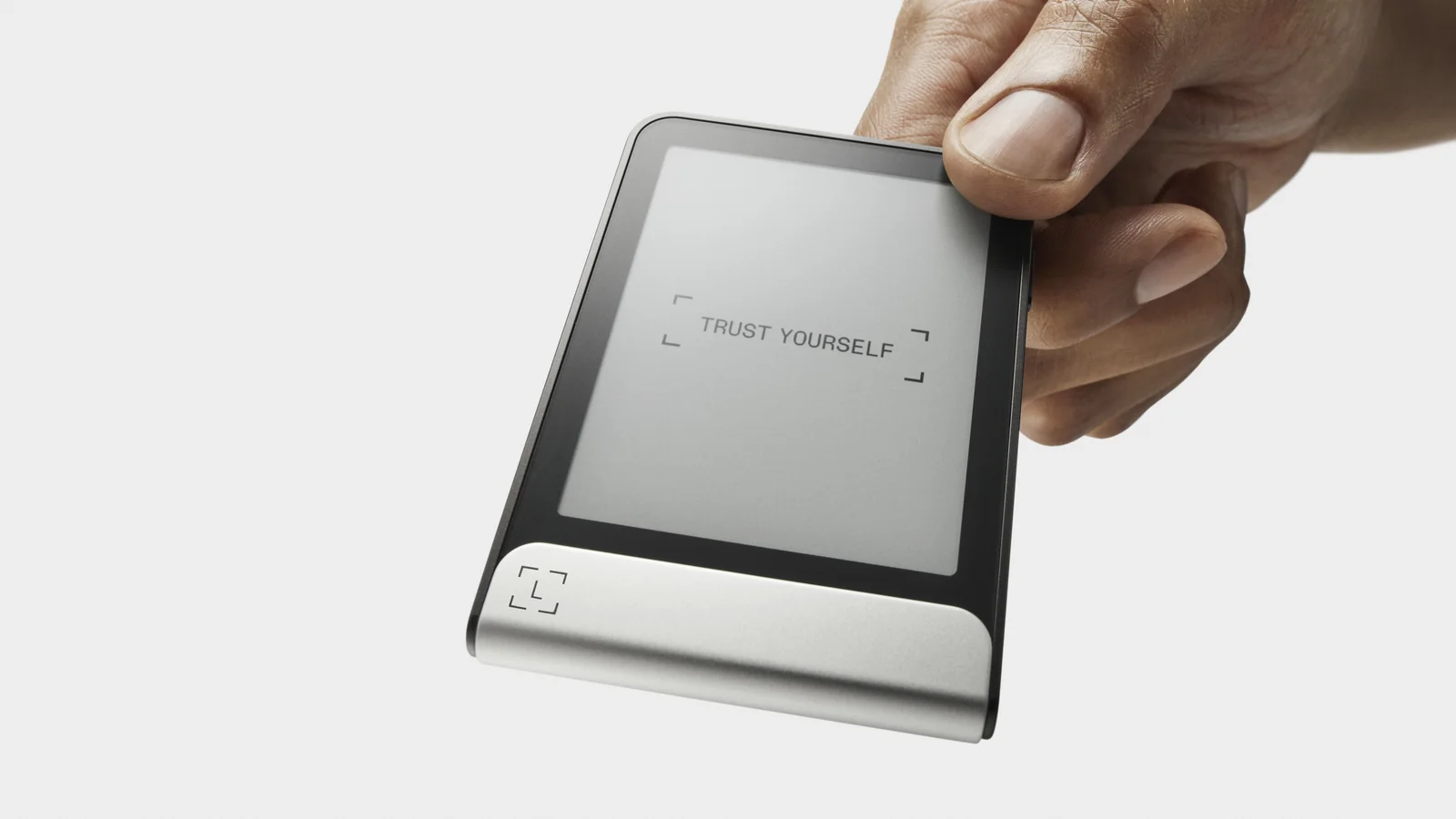 A hand holding a Ledger Flex, showing its flat E Ink touchscreen