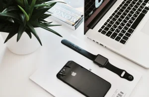 Smartphone and laptop on a white desk, the two places you would run MetaMask or Phantom