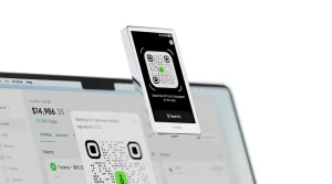 OneKey Pro hardware wallet scanning a transaction QR code shown in the OneKey App on a laptop