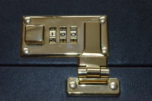 A brass combination lock on a briefcase, illustrating whether to store a seed phrase in a password manager