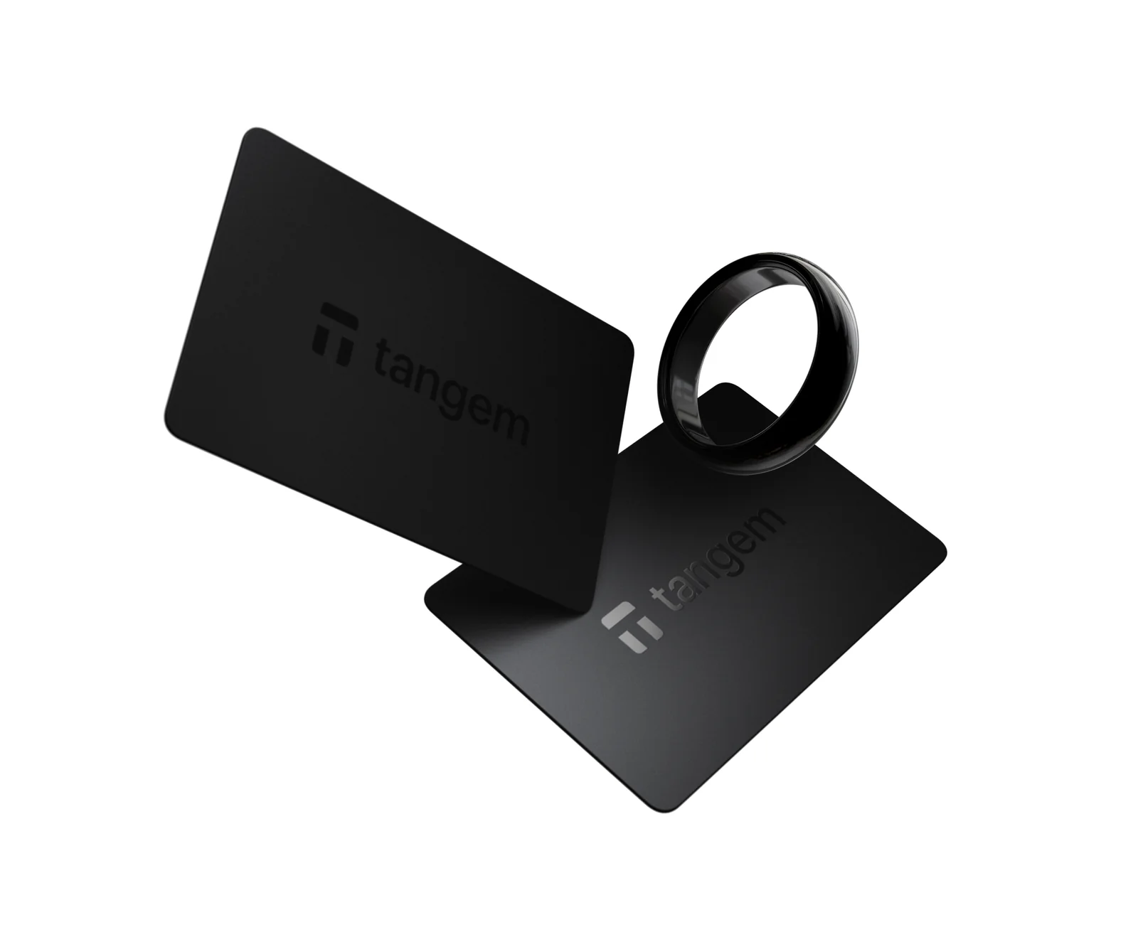 The black Tangem Ring floating beside two black Tangem Wallet cards that serve as its backups