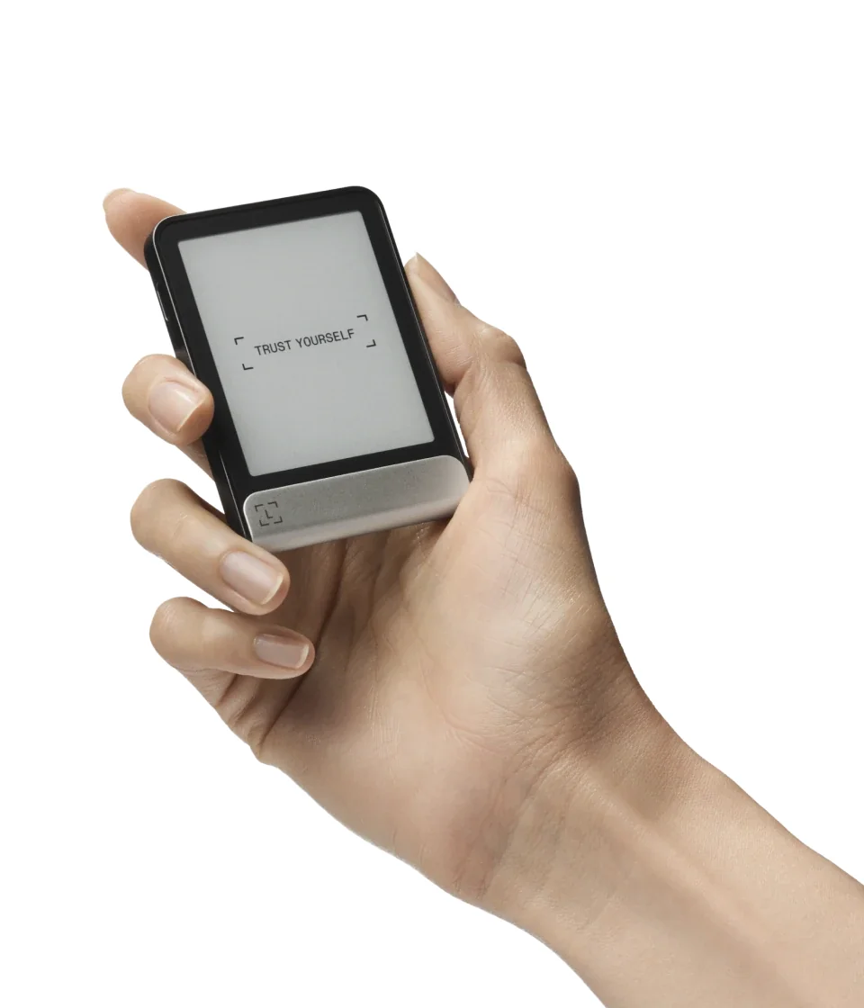 A hand holding the Ledger Flex, showing the size of the 2.8-inch E Ink touchscreen