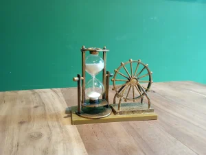 An hourglass with its sand running on a wooden table, a picture of the wait when a crypto transaction is stuck pending