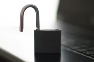 An open padlock on a laptop keyboard, illustrating a crypto wallet that has been hacked