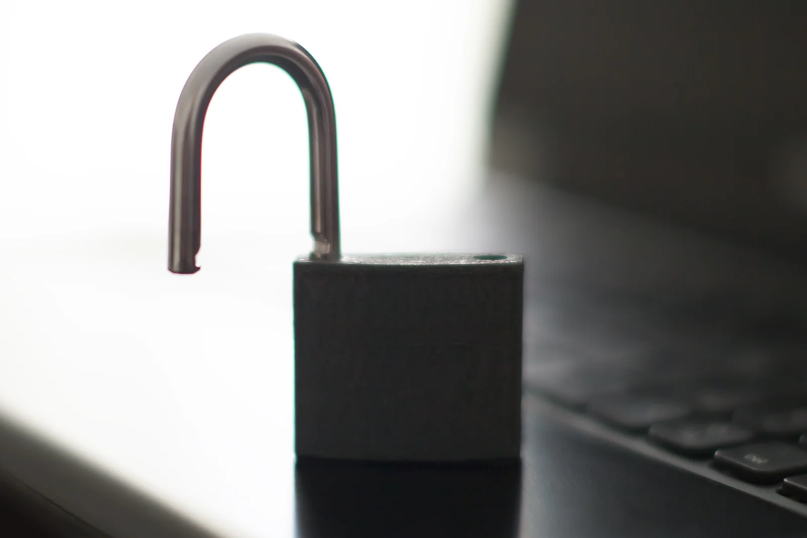 An open padlock on a laptop keyboard, illustrating a crypto wallet that has been hacked