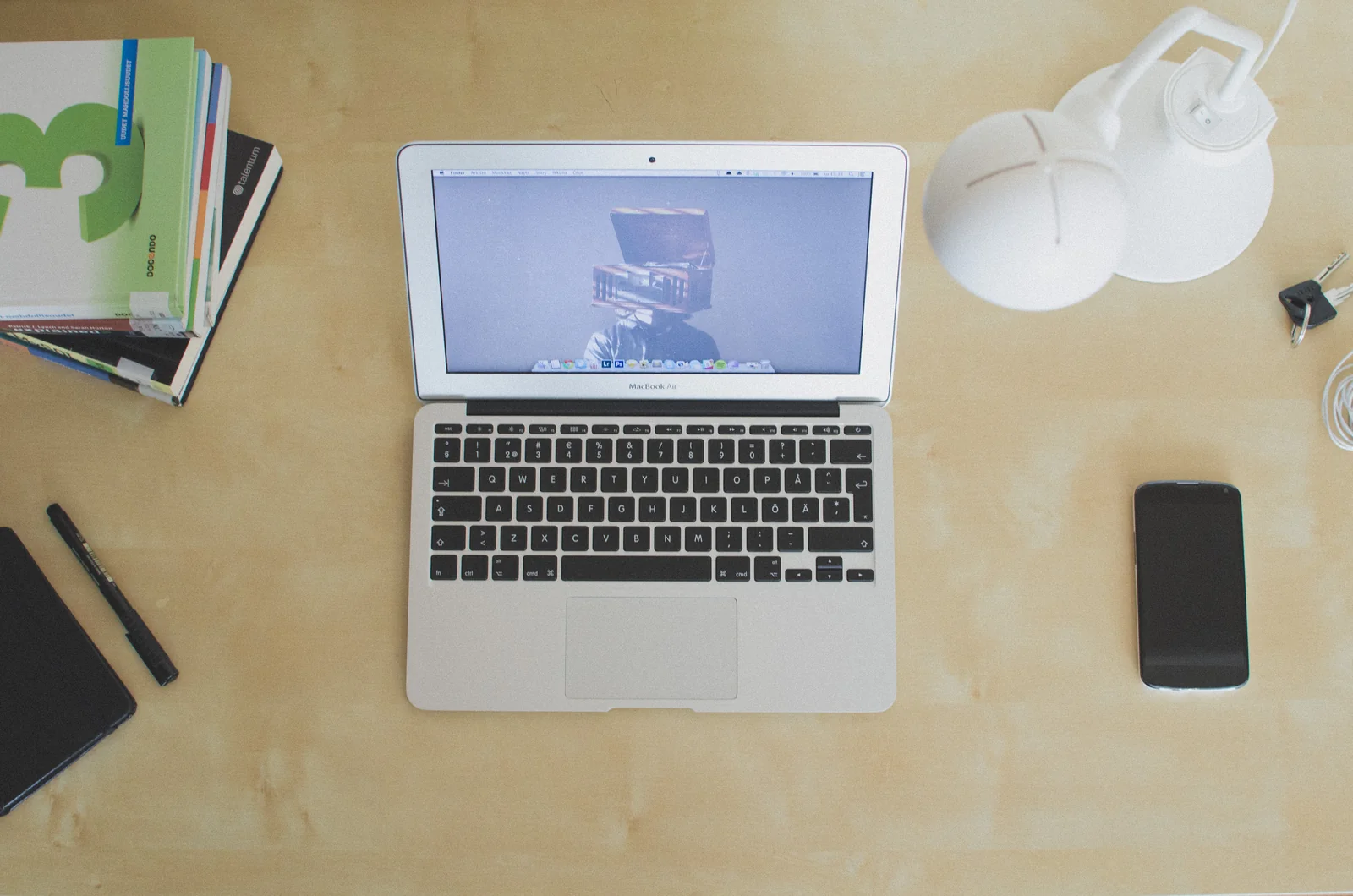 Laptop and smartphone on a light wooden desk, the setup you would run Zerion or Rabby wallet on